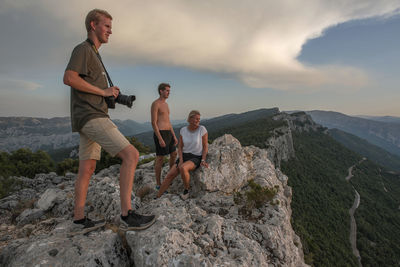 Side view of mother and sons climbing on mountain