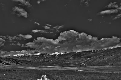 Scenic view of sea and mountains against sky