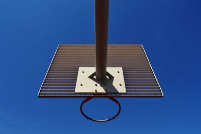 Low angle view of basketball hoop against clear blue sky