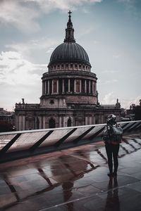 Rear view of woman visiting cathedral against sky