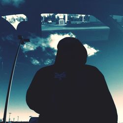 Low angle view of people against sky