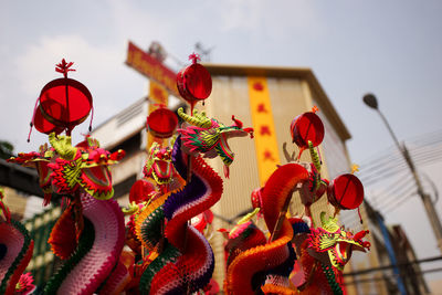 Low angle view of red lanterns hanging against sky