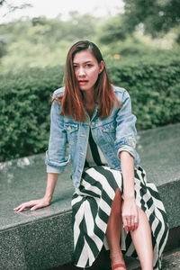 Portrait of a young woman sitting outdoors