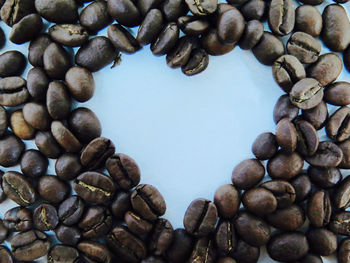 Directly above shot of heart shape coffee beans on table