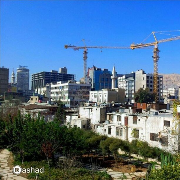 BUILDINGS IN CITY AGAINST BLUE SKY