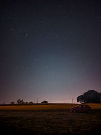 Scenic view of field against sky at night