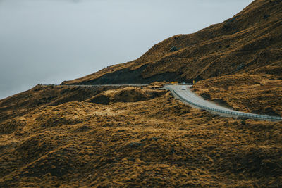 Scenic view of mountains against sky with road