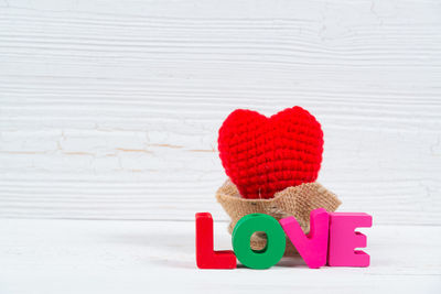 Close-up of heart shape on pink table