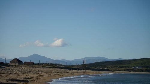 Scenic view of mountains against blue sky