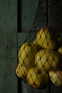 Close-up of yellow bell hanging on wall