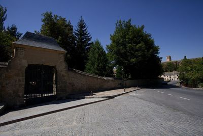 Empty road along buildings