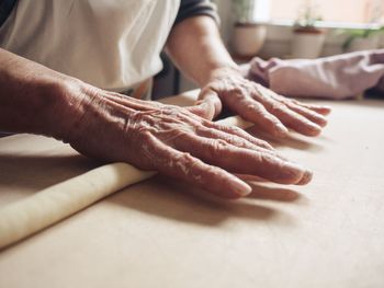 Midsection of man working on table