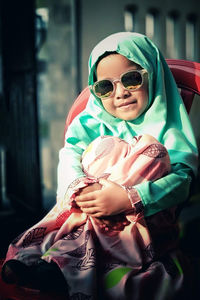 Portrait of a smiling girl wearing sunglasses