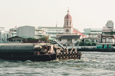 View of boats in sea against buildings