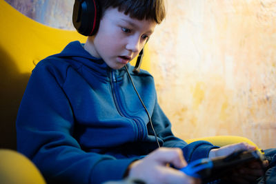 Boy games at home with devise in headset