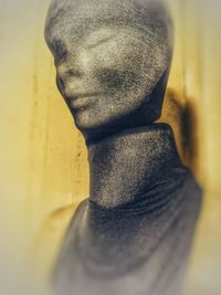 Close-up portrait of young man against wall