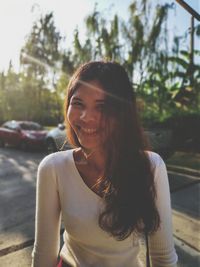 Portrait of smiling young woman during sunny day