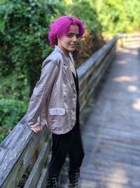 Full length of woman standing on railing