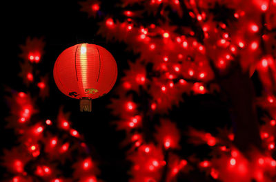 Close-up of illuminated lanterns hanging at night