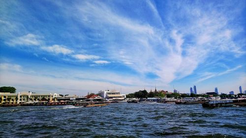 Scenic view of sea and buildings against sky