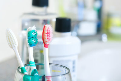 Close-up of multi colored toothbrushes in bathroom