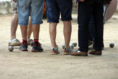 Low section of people with balls standing on ground