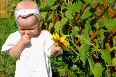 Laughing baby girl with sunflower