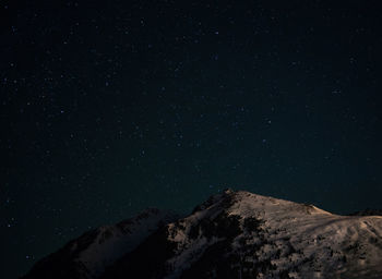 Low angle view of mountain against sky at night