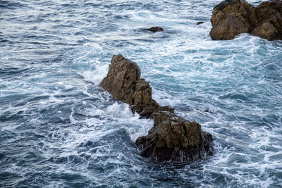 High angle view of rock formation on sea