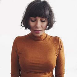 Portrait of beautiful young woman against white background