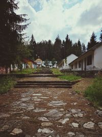 Surface level of footpath by buildings against sky