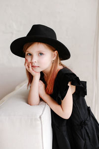 Portrait of young woman wearing hat