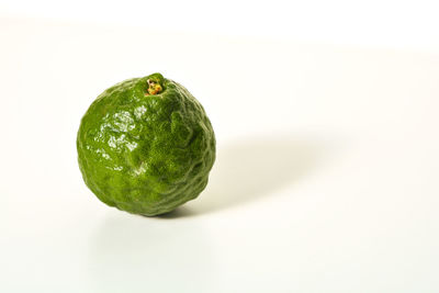 Close-up of green apple against white background