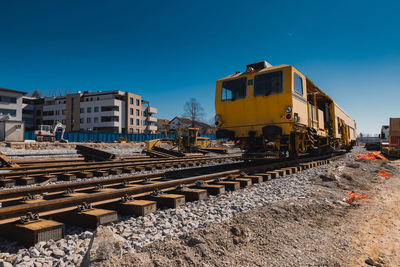 Railroad tracks against clear blue sky