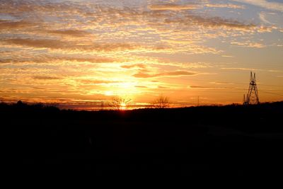 Silhouette landscape against sky during sunset