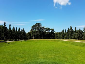 Scenic view of golf course against sky