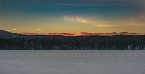 Scenic view of landscape against sky during winter