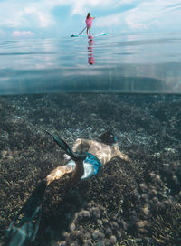 Young couple have a fun in ocean, underwater view