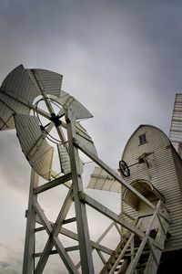 Low angle view of traditional windmill against sky