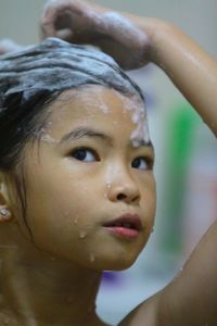 Close-up of girl looking away while bathing