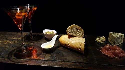 Close-up of drinks on table against black background