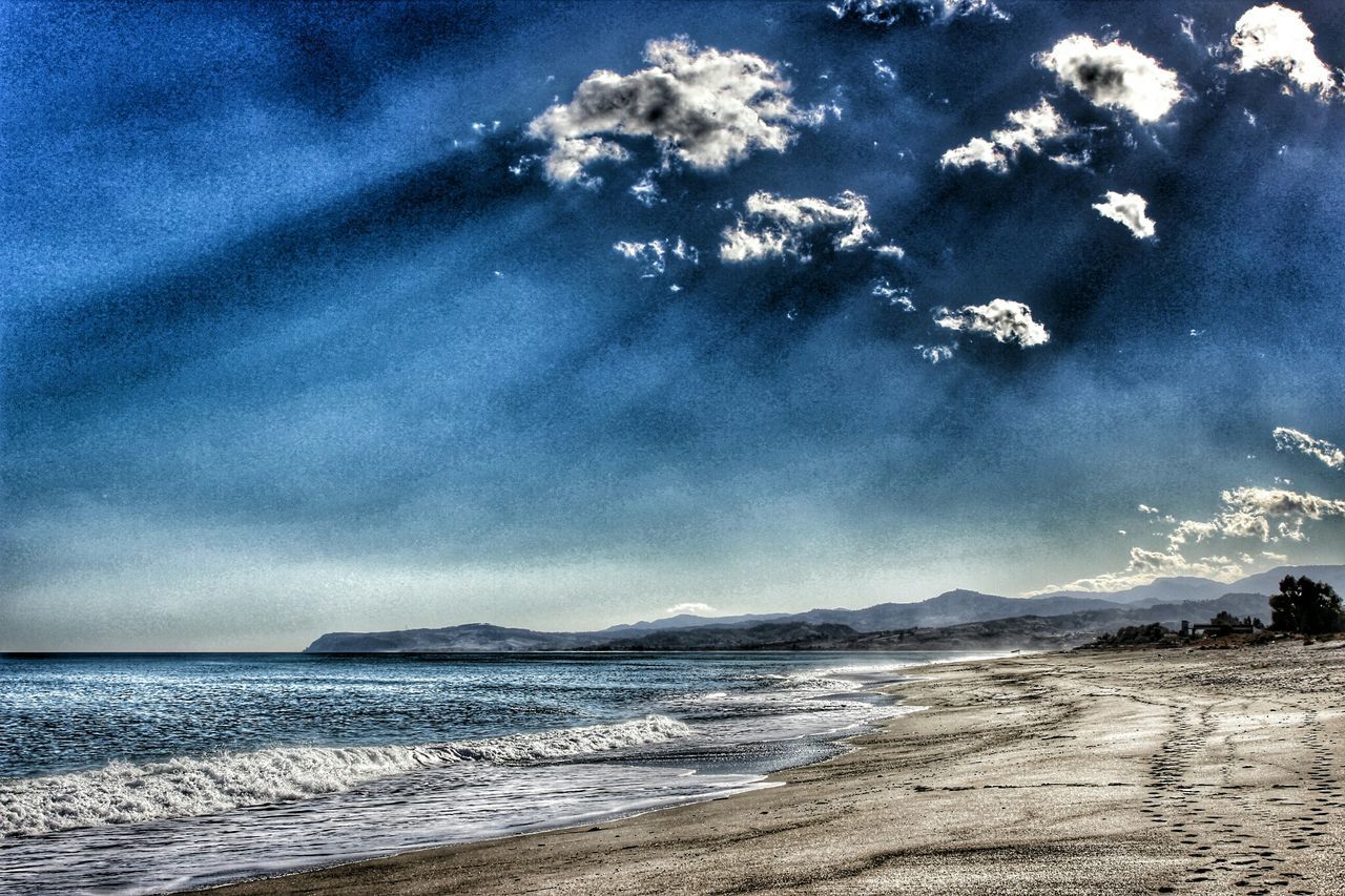 sea, beach, water, sky, scenics, tranquil scene, tranquility, beauty in nature, shore, horizon over water, sand, nature, cloud - sky, coastline, wave, idyllic, cloud, cloudy, blue, remote