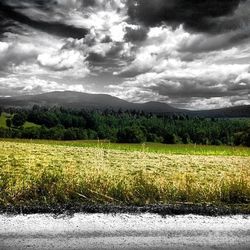 Scenic view of landscape against cloudy sky