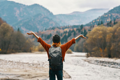 Rear view of man with arms outstretched