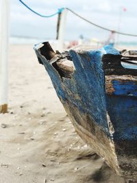 Close-up of rusty metal on beach