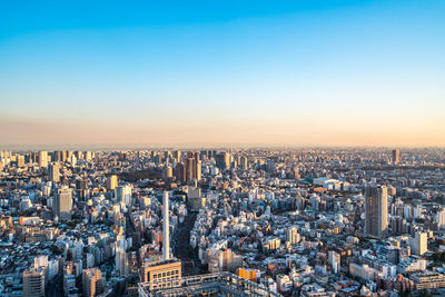 High angle view of city buildings against clear sky