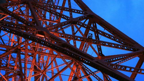 Low angle view of metallic structure against blue sky