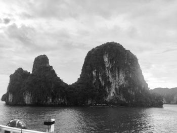 Scenic view of sea and rock formation against sky