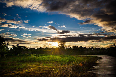 Scenic view of field against sky during sunset