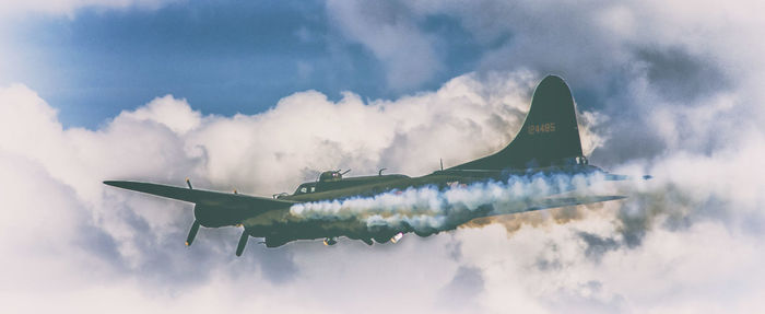 Low angle view of airplane flying in sky